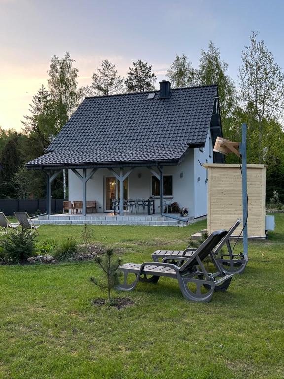 a house with a picnic table in the yard at Masuria Miracle dom nad jeziorem z sauną in Świętajno