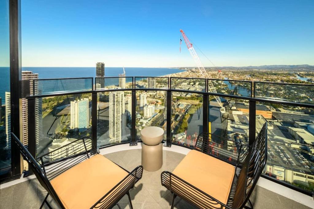 a balcony with two chairs and a view of the city at Cloud Nine Retreat - Luxe 44th Fl Apartment in Gold Coast