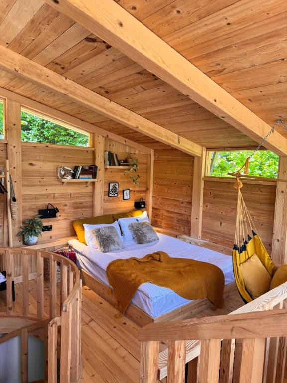a bedroom with a hammock in a log cabin at Hotel Borjomi Verde in Borjomi