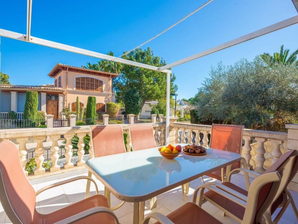 a patio with a table and chairs on a balcony at North House - House In Platja De Muro Free Wifi in Playa de Muro