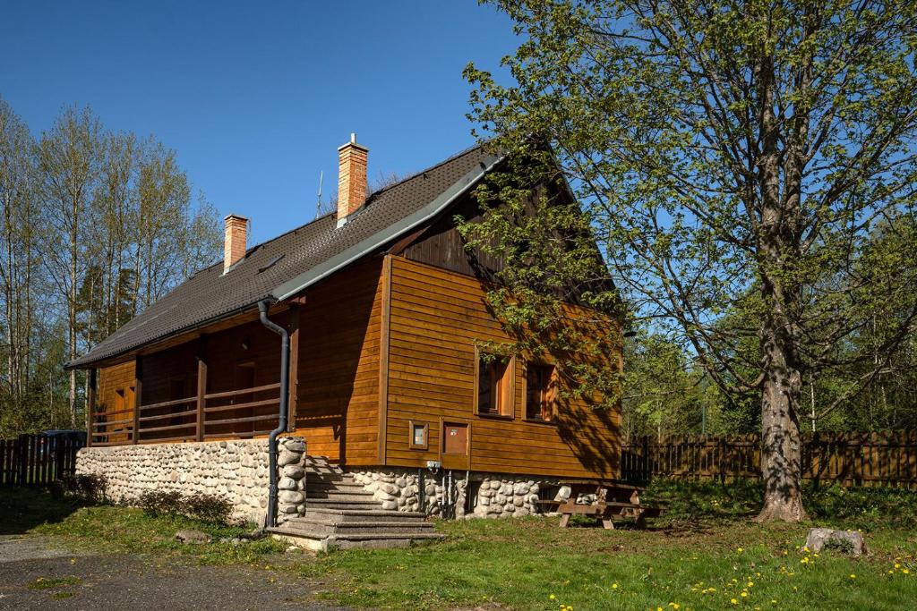 a large wooden house with a gambrel roof at Chata Dolný Smokovec Správa TANAPu in Starý Smokovec
