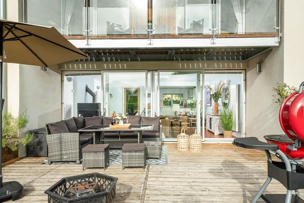 a living room with a couch and a table at Roseberry Cottage - Lower Mill Estate in Somerford Keynes