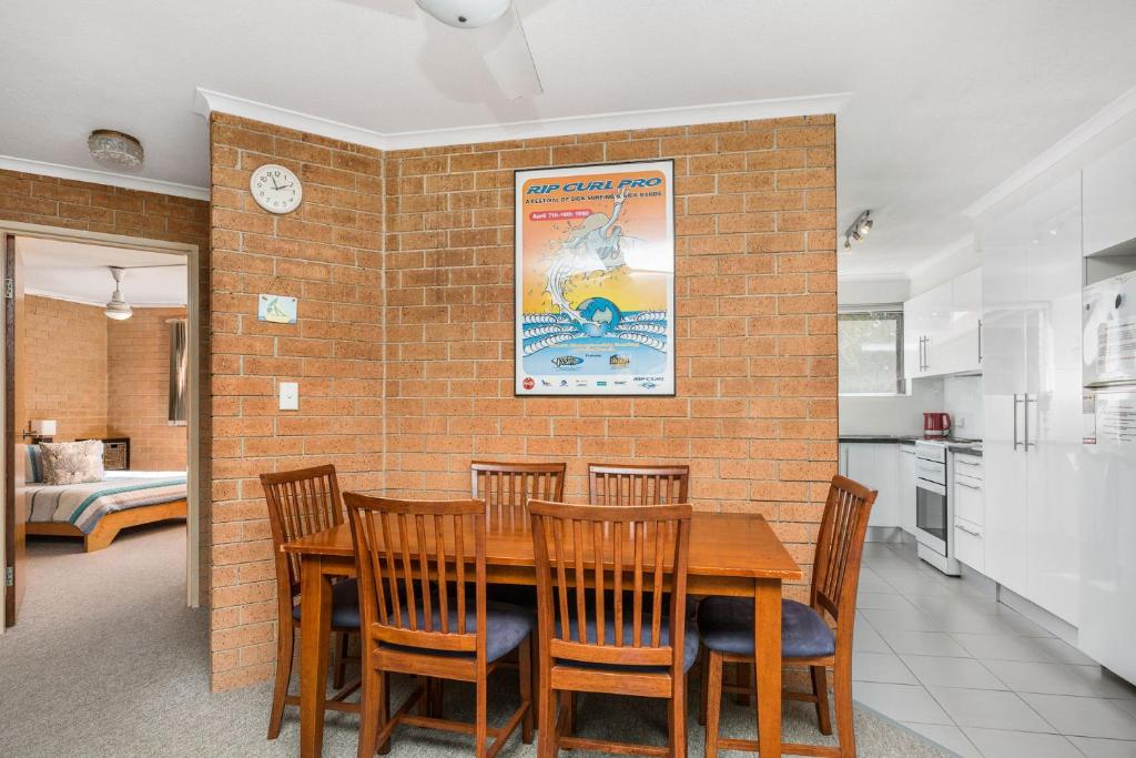 a kitchen and dining room with a wooden table and chairs at 1 In Bruns in Brunswick Heads