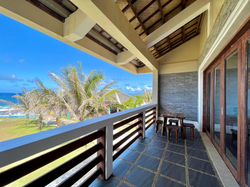 a balcony with a view of the ocean at Balay Pacifico in Sarog