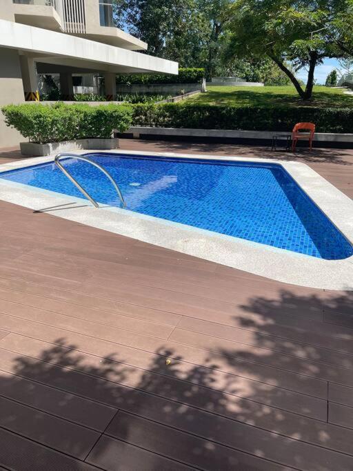 a large blue swimming pool next to a building at Ma Roberta - Tambuli Resort with fast Wifi 16 Floor Studio Type in Lapu Lapu City