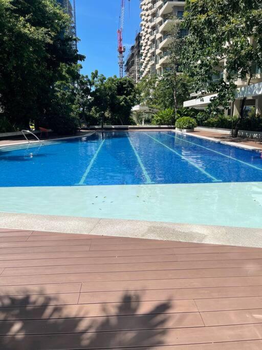 a large blue swimming pool in a city at Ma Roberta - Tambuli Resort with fast Wifi 16 Floor Studio Type in Lapu Lapu City