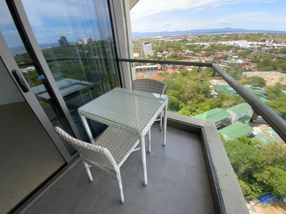 a table and chairs on the balcony of a building at Ma Roberta - Tambuli Resort with fast Wifi 16 Floor Studio Type in Lapu Lapu City