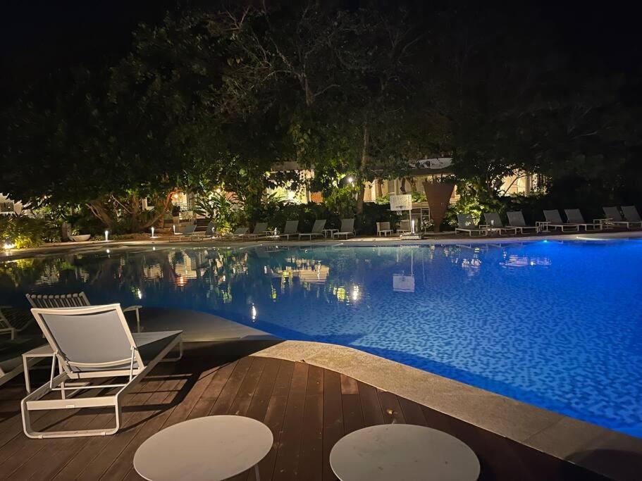 a swimming pool at night with a chair and tables at Ma Roberta - Tambuli Resort with fast Wifi 16 Floor Studio Type in Lapu Lapu City