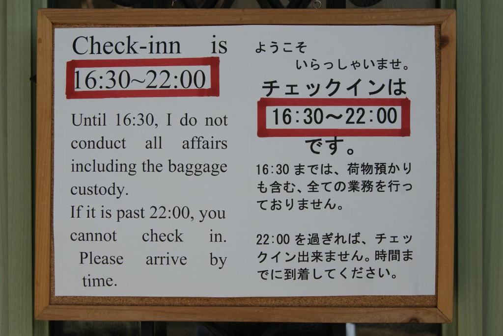 a sign that says check him is at Guesthouse Haru Kitamachi in Nara