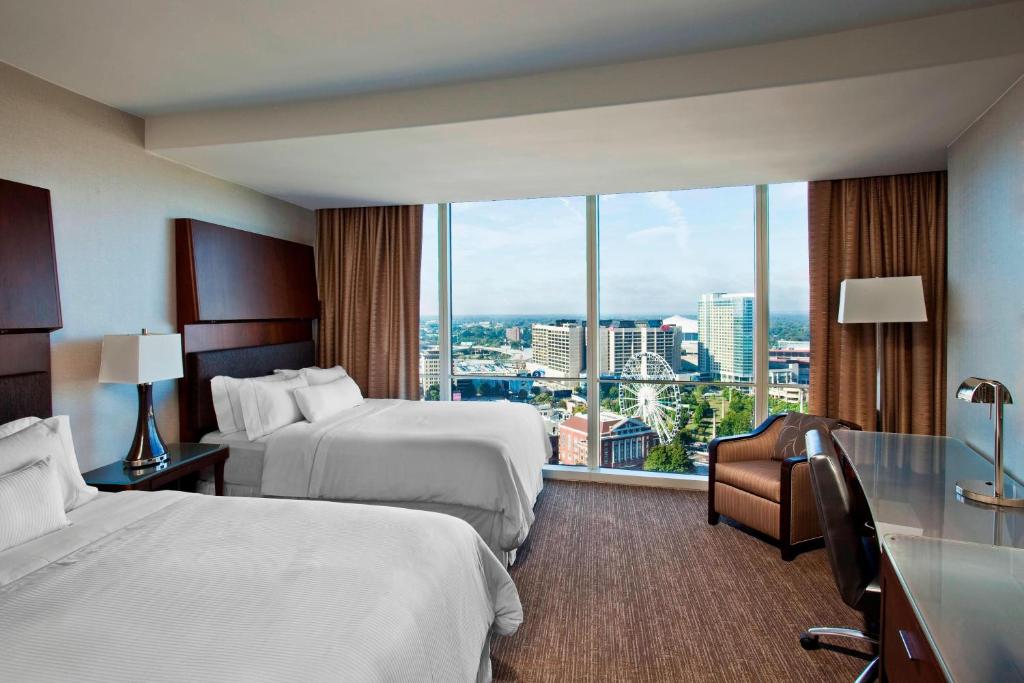 a hotel room with two beds and a large window at The Westin Peachtree Plaza, Atlanta in Atlanta