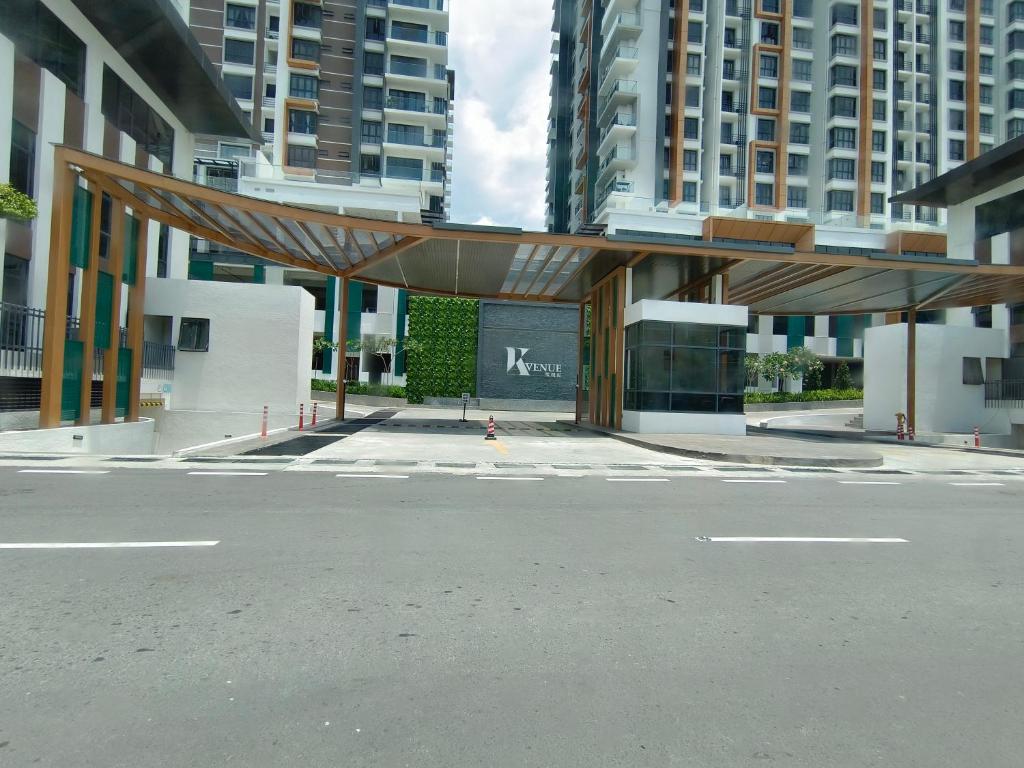 a building with a canopy in the middle of a street at K-Avenue JANNATH269 HOMESTAY KKIA KK in Donggongon