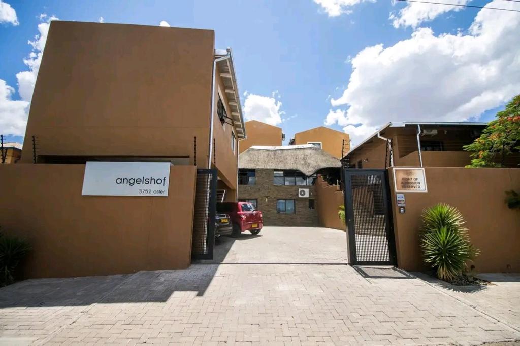 an entrance to an apartment building with a garage at Angelshof Self Catering Guesthouse in Windhoek