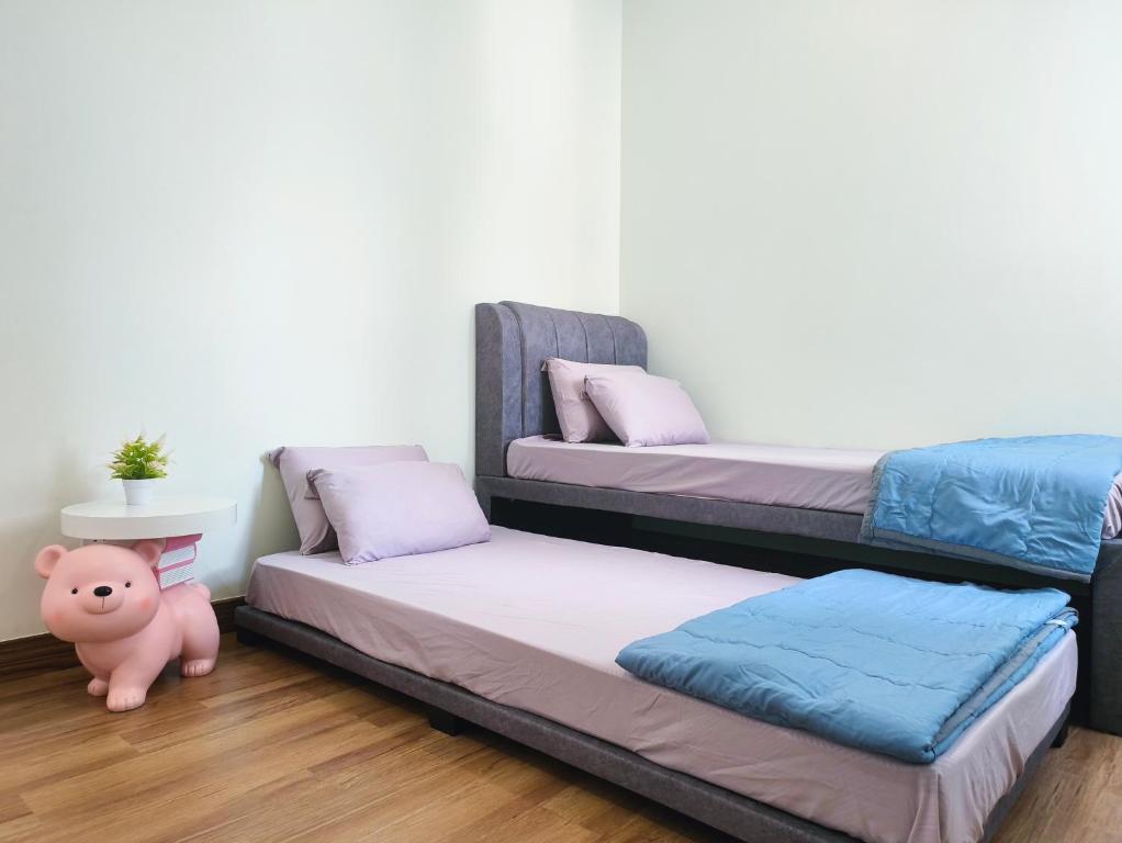 a room with two bunk beds and a pig toy at APPLE CloverLeafs Homestay Melaka in Melaka