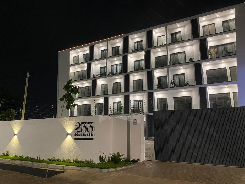 a building with a sign in front of it at night at Hovah Luxury Suite in Accra