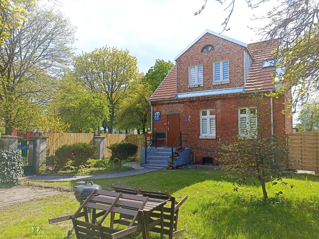 a brick house with a picnic table in the yard at Seaside Holiday House in Gdańsk