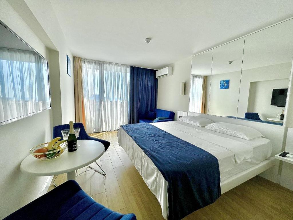 a hotel room with a bed and a table at Orbi City Hotel VIP - Batumi in Batumi