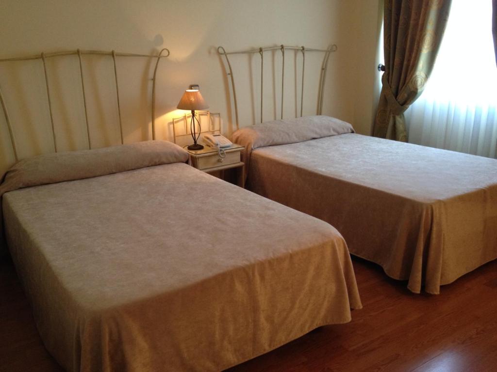 Postel nebo postele na pokoji v ubytování Hotel Villa De Ferias