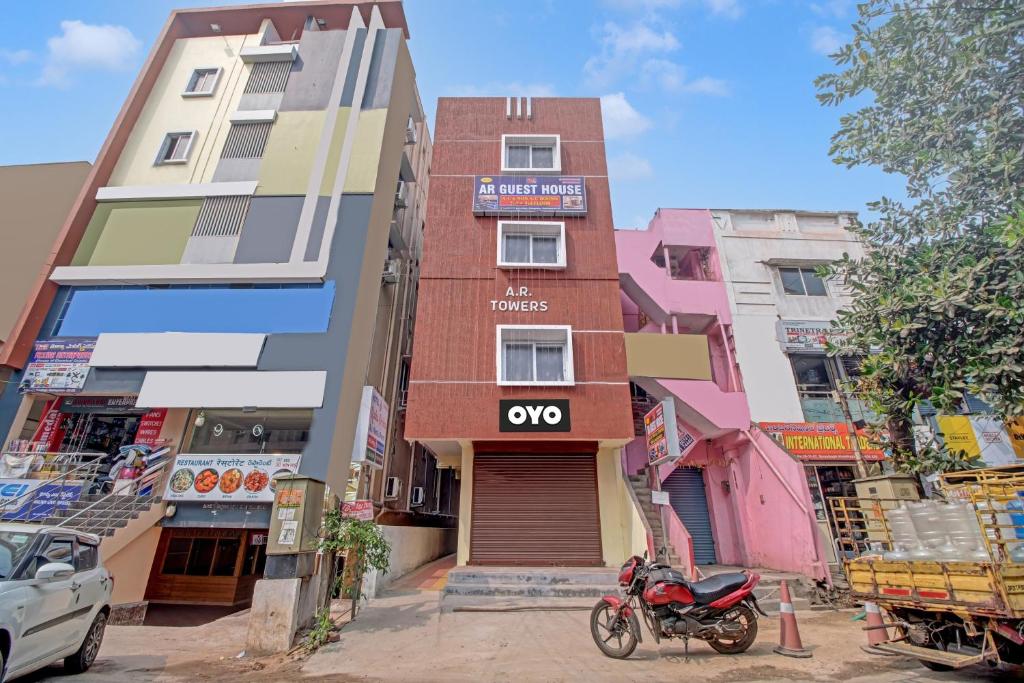 a building with a motorcycle parked in front of it at OYO AR Guest House in Visakhapatnam