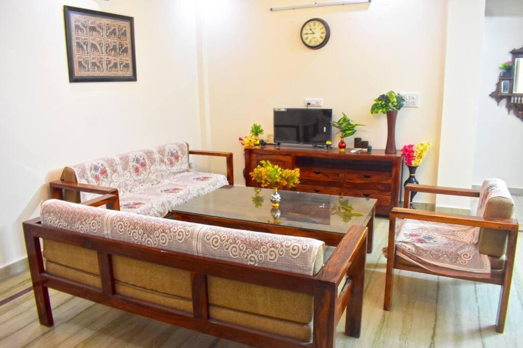 a living room with a couch and a coffee table at Budget Friendly 3 BHK + Prime Location in Faridabad