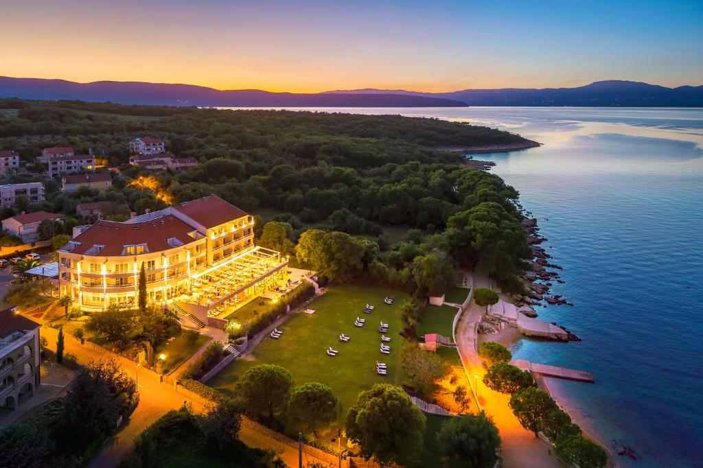 an aerial view of a hotel on the shore of a lake at Spa & Wellness Hotel Pinia in Malinska