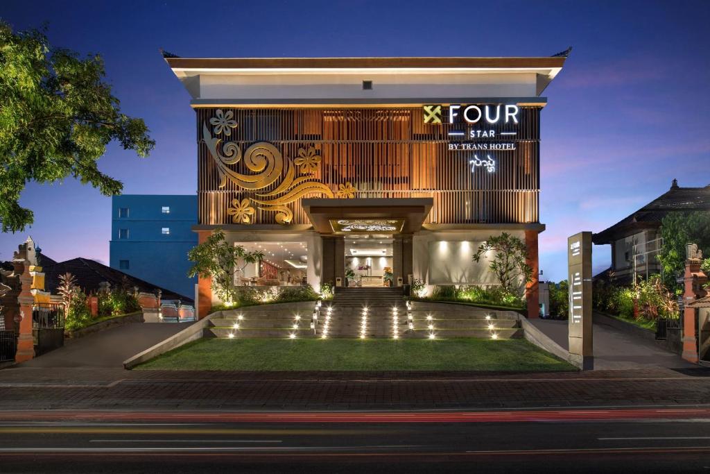 a front view of a four star hotel at night at Four Star by Trans Hotel in Sanur