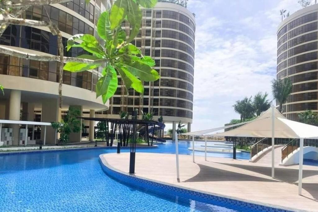 una piscina en el medio de un edificio con edificios altos en Relaxing Private Studio with Luxurious Pool and Gym By SYM B735 en Phnom Penh