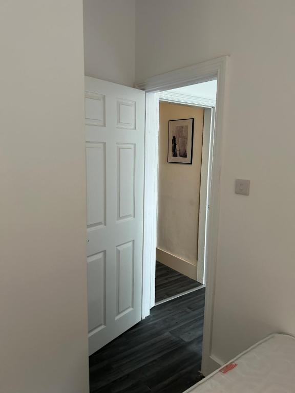 an empty room with a door and a hallway at ChaRloHub 01 in Coventry