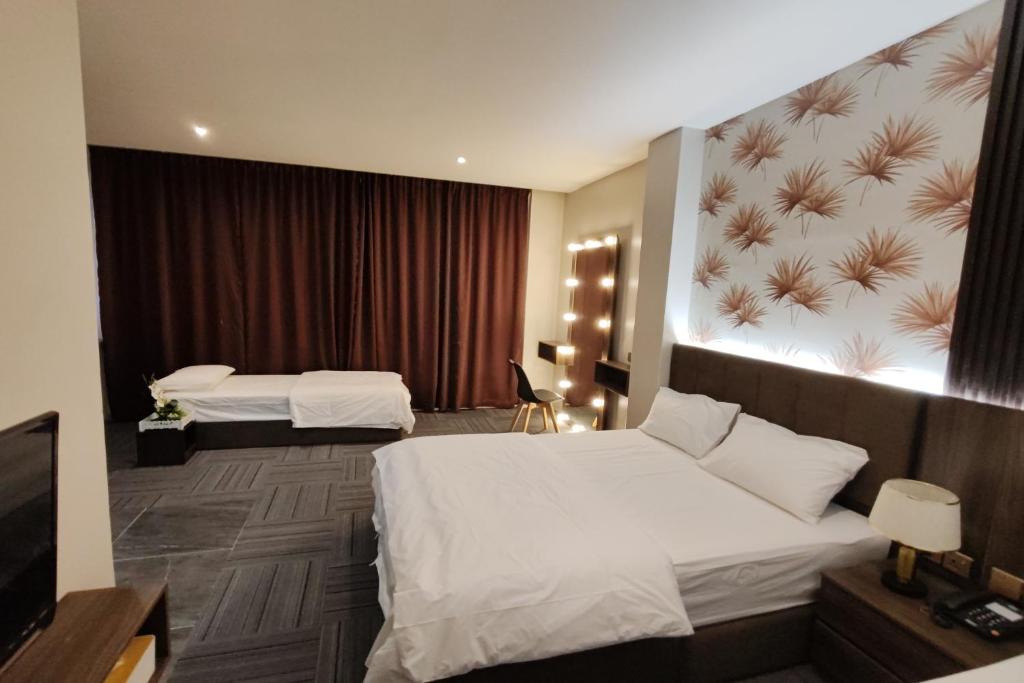 Postel nebo postele na pokoji v ubytování Casa Colney Hotel Ipoh
