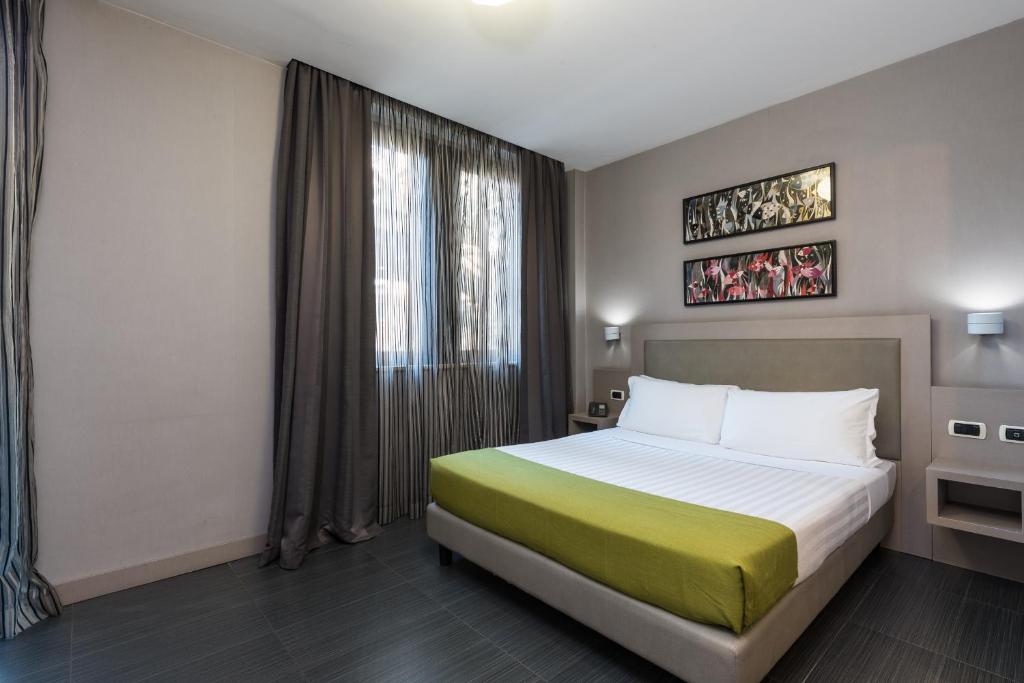 Llit o llits en una habitació de Noba Hotel e Residenze