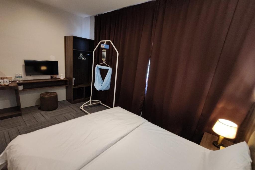 Postel nebo postele na pokoji v ubytování Casa Colney Hotel Ipoh