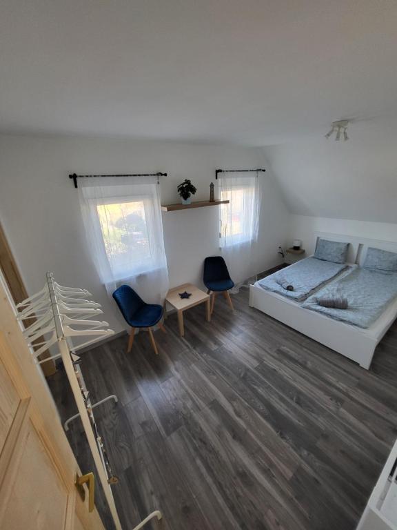 um quarto com uma cama e duas cadeiras em WHS Apartments em Monostorapáti