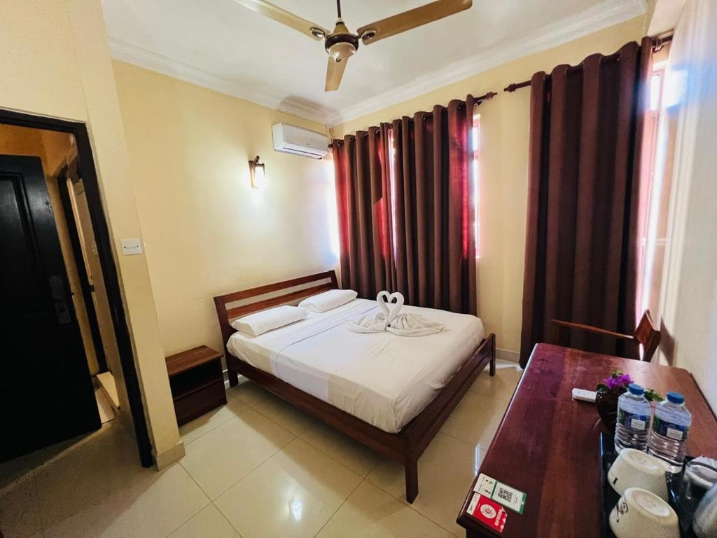 Postel nebo postele na pokoji v ubytování Lafala Hotel & Service Apartment