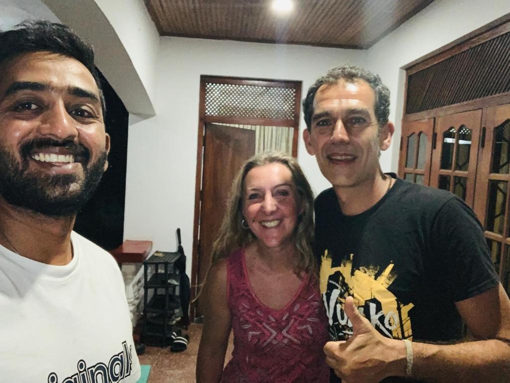 two men and a woman posing for a picture at Ceylon Glory Hostel in Negombo