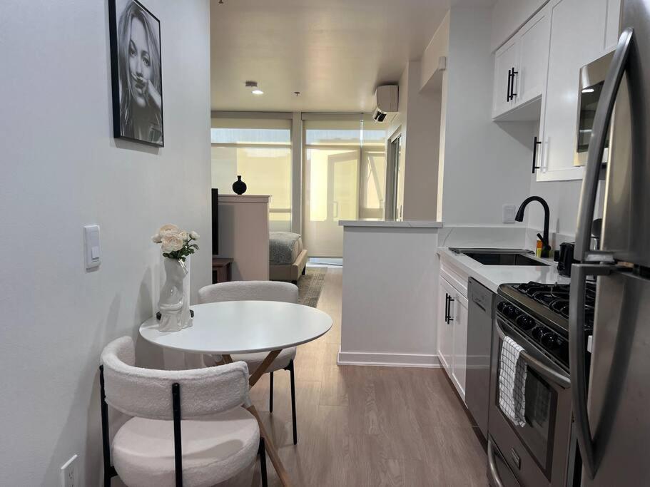 a kitchen with a table and a small table with chairs at Seaside Retreat in Santa Monica, steps to the beach, free parking in Los Angeles