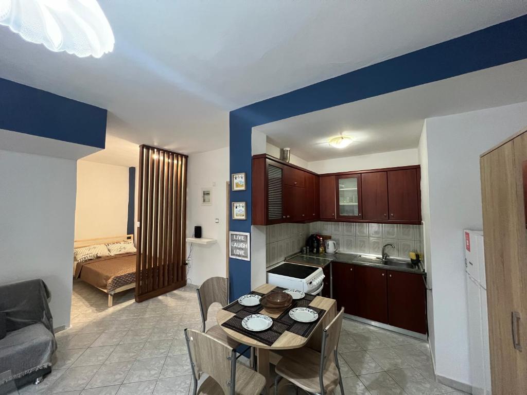a kitchen and a dining room with a table and chairs at Dimitris Flat in Neoi Epivates