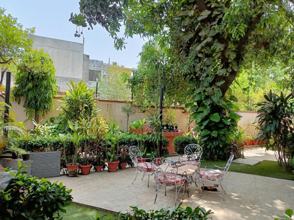 a patio with a table and chairs and plants at Homestay in Connaught Place in New Delhi