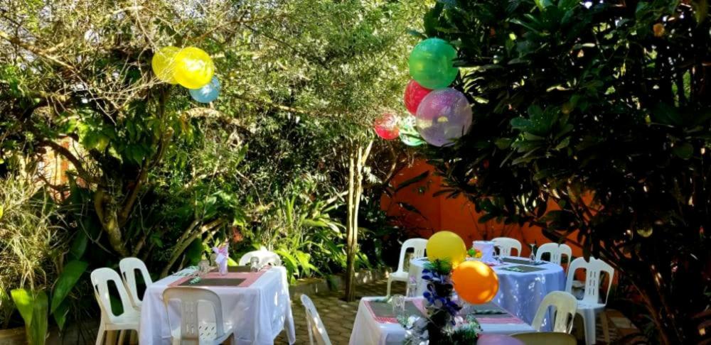 a group of tables and chairs with balloons on them at Nilenian Holiday Villas in Jinja