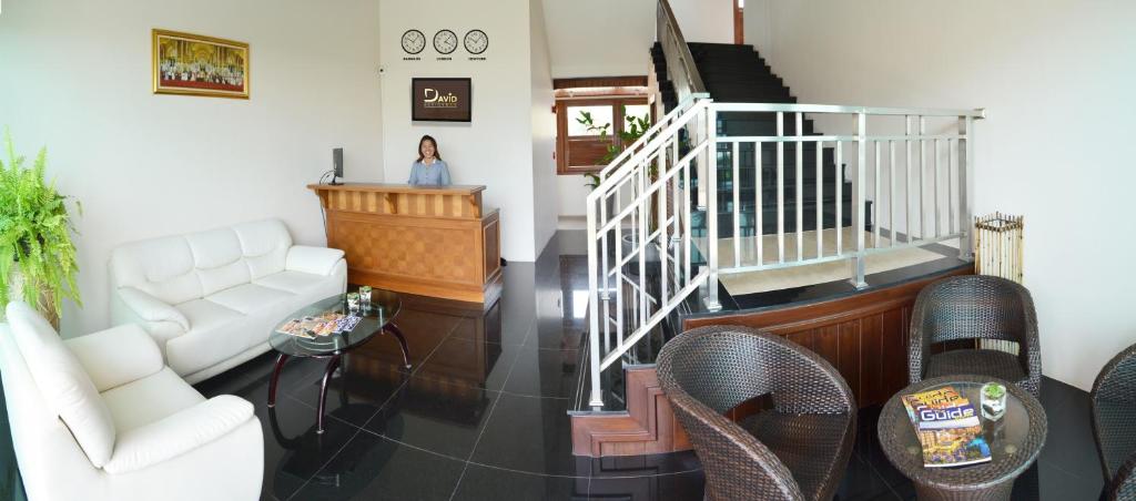 a woman is standing in a living room at David Residence in Nai Yang Beach