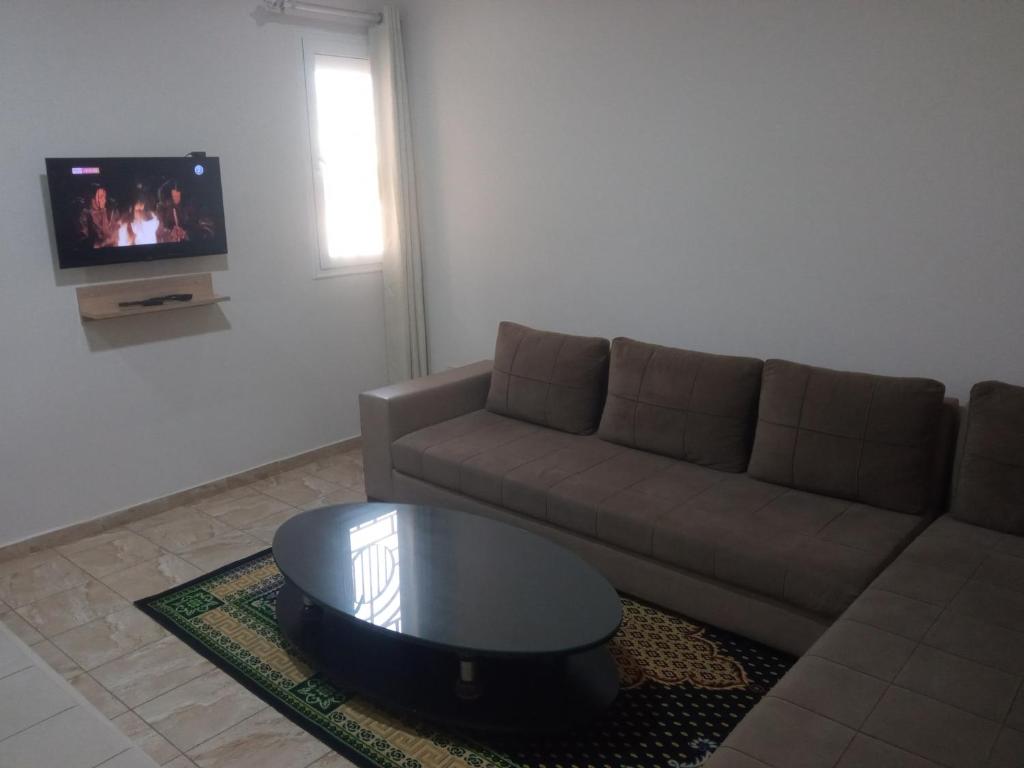 a living room with a couch and a coffee table at Lovely Paradise in Sfax