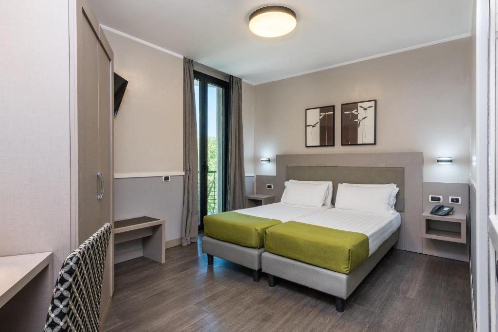 Llit o llits en una habitació de Noba Hotel e Residenze