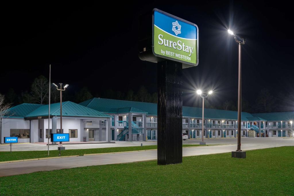 a street sign in front of a building at night at SureStay by Best Western Gulfport in Gulfport