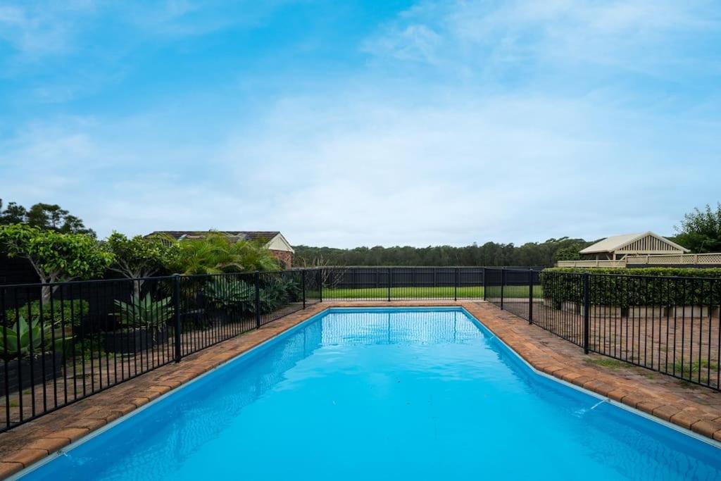 a swimming pool with a fence around it at LAGOON HOUSE // POOL // PET FRIENDLY in Bellambi