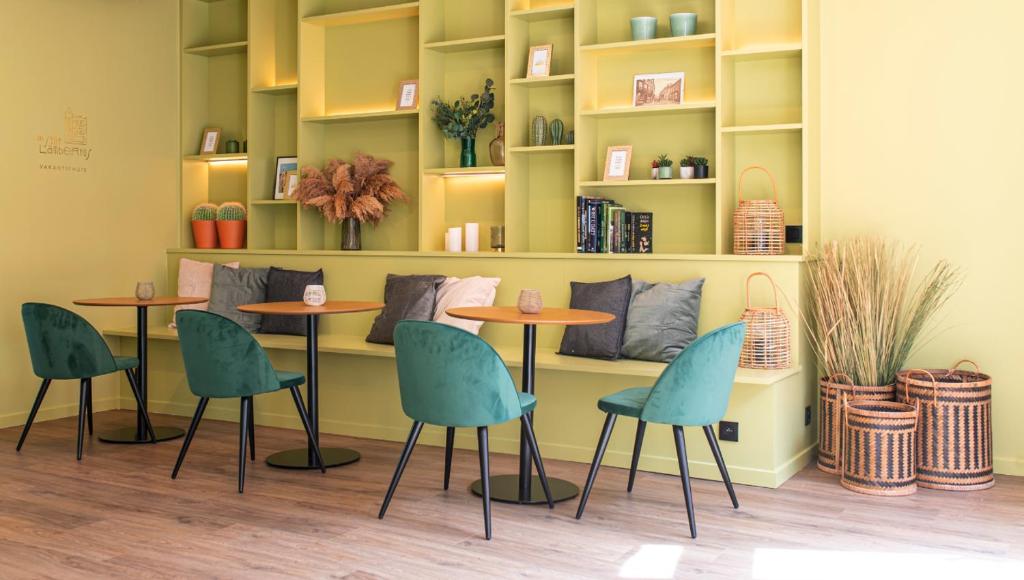 a room with two tables and chairs and shelves at In Sint Lambertus in Hasselt