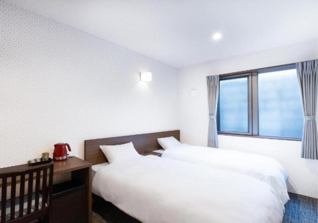 Postel nebo postele na pokoji v ubytování HOTEL DORIA