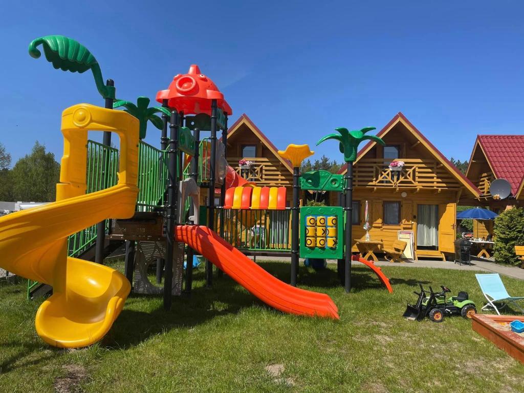 a playground in front of a house at Złoty Brzeg Wicie in Wicie