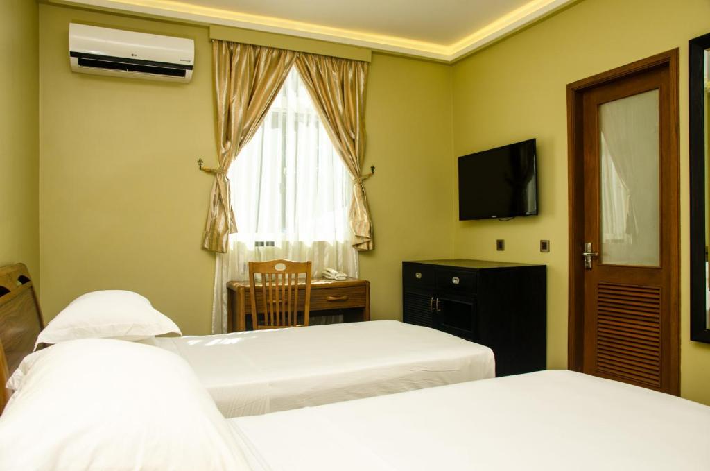 Postel nebo postele na pokoji v ubytování Fuvahmulah Central Hotel