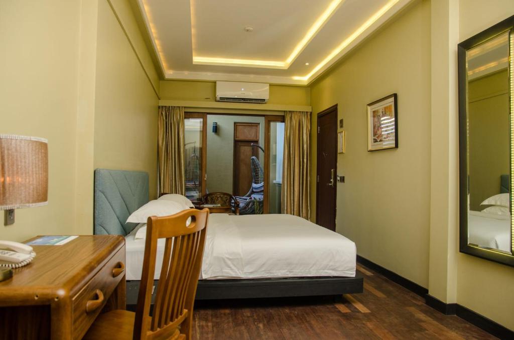 Postel nebo postele na pokoji v ubytování Fuvahmulah Central Hotel