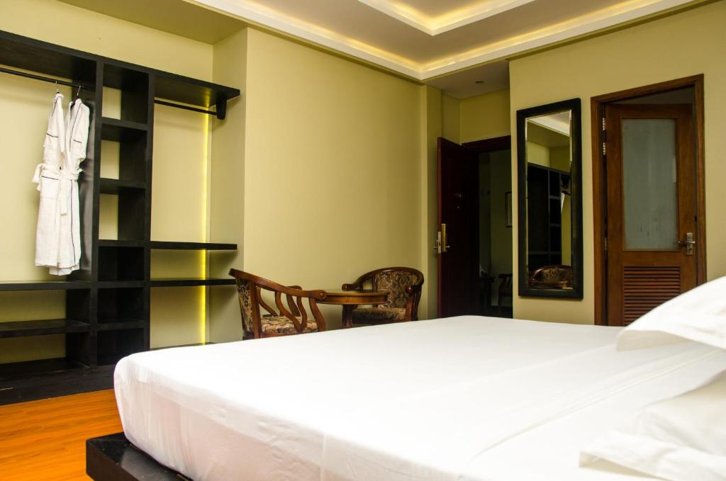 Postel nebo postele na pokoji v ubytování Fuvahmulah Central Hotel