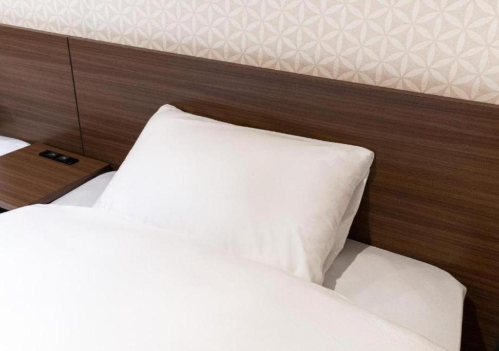 Postel nebo postele na pokoji v ubytování HOTEL DORIA