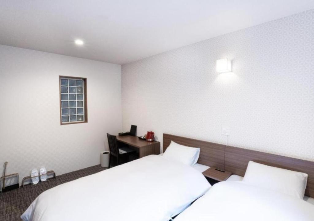 Postel nebo postele na pokoji v ubytování HOTEL DORIA